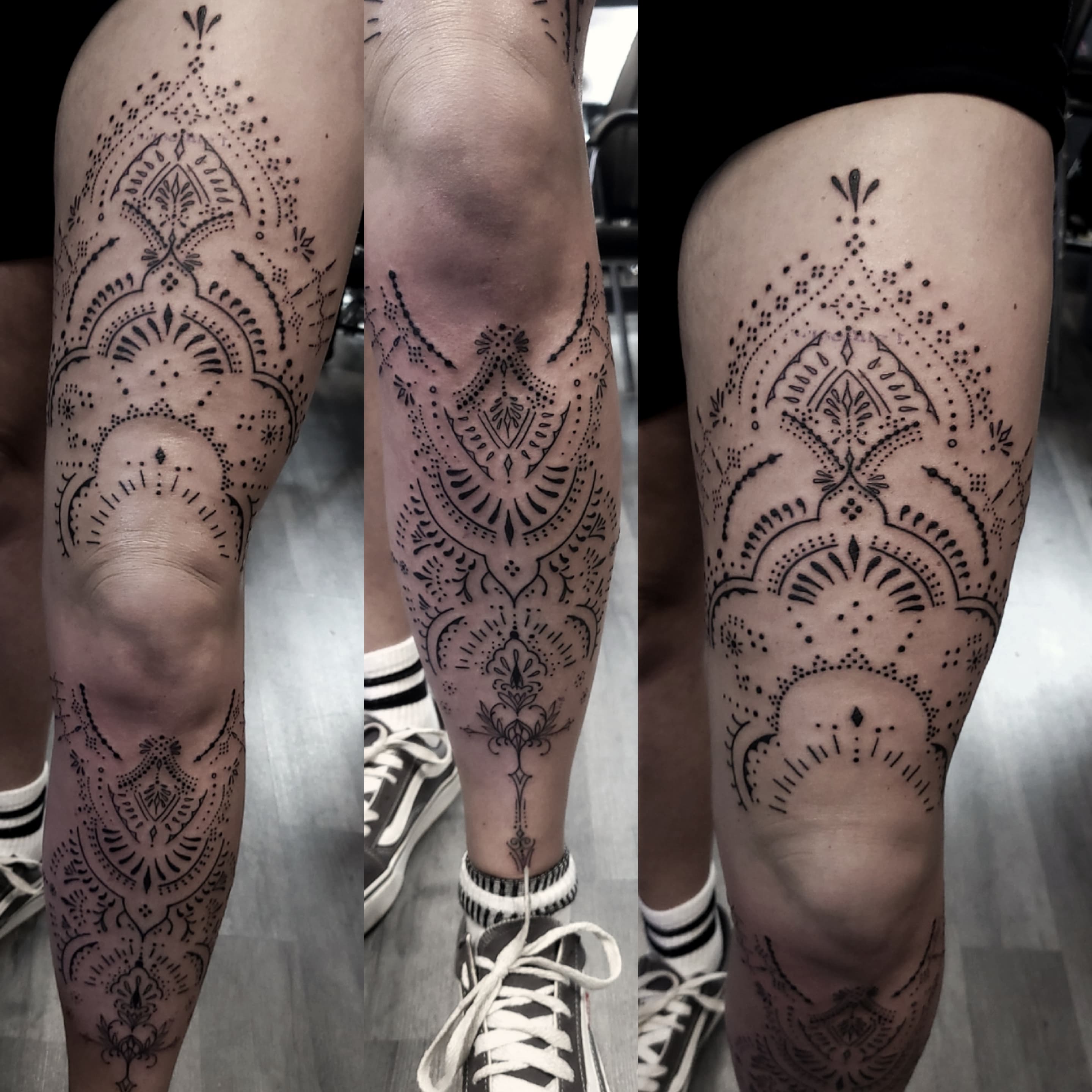 Czarny ornamentalny tatuaż w stylu henna z delikatnymi wzorami na nodze